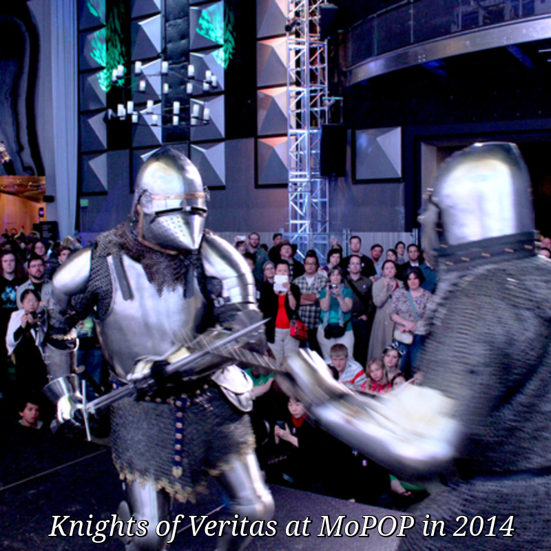 Image of two presenters from Knights of Veritas demonstrating authentic German medieval martial arts, based on fighting manuals from the 1300s-1400s. Both presenters are wearing museum-quality replica armor and using accurate steel sword replicas. Picture was taken at the EMP Museum (now known as MoPOP) in Seattle at their 2014 opening night gala. 